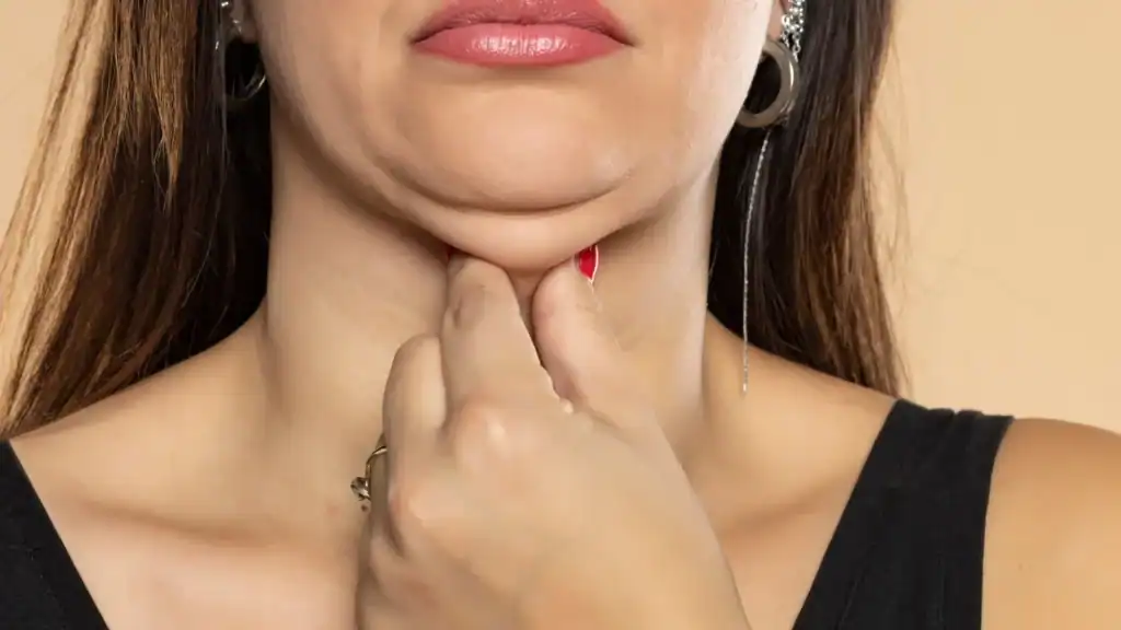 An image of a woman with double chin, sad, worried : Non Surgical Double Chin Removal Treatment in Coombe, UK