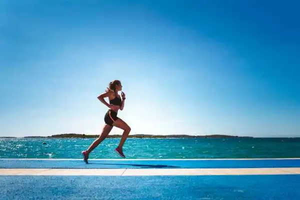 Woman running showing strong leg muscle Coombe